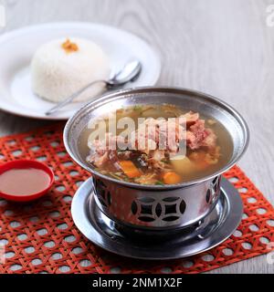 Sop Buntut Oxtail Soup with Potato and Carrot Served with White Rice, on the Table Stock Photo