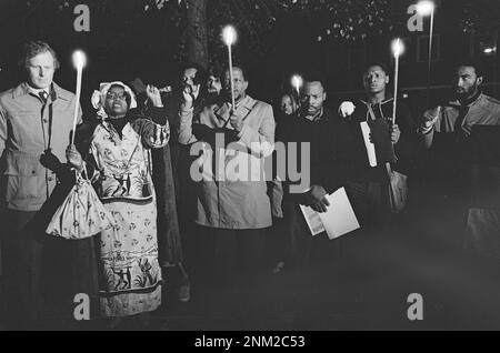 Vigil for African poet Benjamin Moloise who was executed; South Africans sing songs at the monument in Amsterdam ca. 1985 Stock Photo