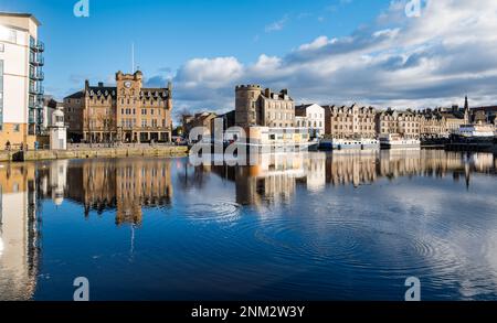 Leith, Edinburgh, Scotland, UK, 24th February 2023. UK Weather: sunshine on Leith. The sun shines on a beautiful Spring-like afternoon creating reflections of the historic buildings and houseboats in the river on The Shore at the Water of Leith. Credit: Sally Anderson/Alamy Live News Stock Photo