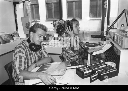 Ether pirate becomes legal youth radio WAPS; WAPS employee in their studio above the IJsbreker in Amsterdam (interior of a once pirate radio station) ca. 1985 Stock Photo