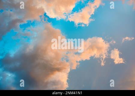 Beautiful dramatic orange clouds on blue sky in the evening Stock Photo