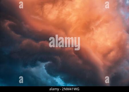 Beautiful dramatic colorful storm clouds in the sunset sky Stock Photo