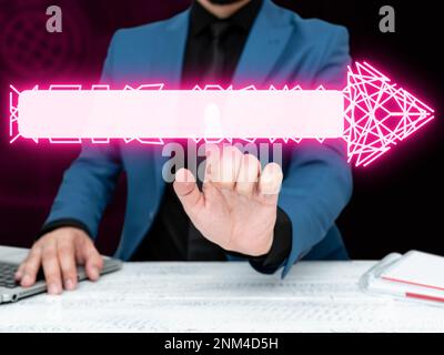 Businessman in blue jacket sitting at the white table and pressing virtual button. Laptop laying on the desk.Futuristic style image with colored glow. Stock Photo