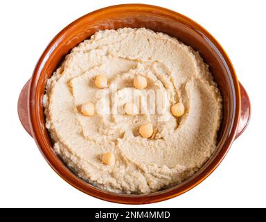 Home made hummus bowl, decorated with boiled chickpeas on white background