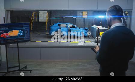 Male engineer simulates and watches process of traffic accident using ...