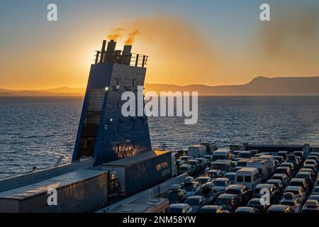 Car ferry from Grimaldi Lines sailing on the Adriatic Sea at sunset from Italy to Igoumenitsa in Greece Stock Photo