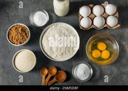 Organic Raw Baking Ingredients with Flour Sugar Milk and Eggs Stock Photo