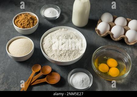 Organic Raw Baking Ingredients with Flour Sugar Milk and Eggs Stock Photo