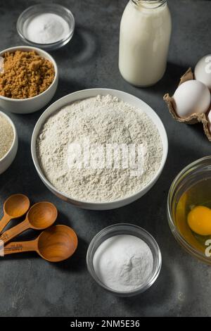 Organic Raw Baking Ingredients with Flour Sugar Milk and Eggs Stock Photo
