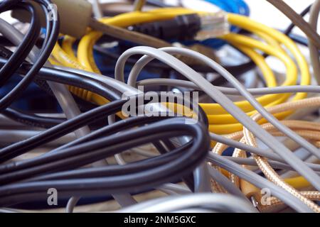 Abstract communication cables background. Messy various cables. Stock Photo