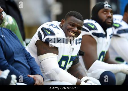 HOUSTON, TX - DECEMBER 12: Seattle Seahawks DE Darrell Taylor watches  action during game featuring the Houston Texans and the Seattle Seahawks on  December 12, 2021 at NRG Stadium in Houston, TX. (