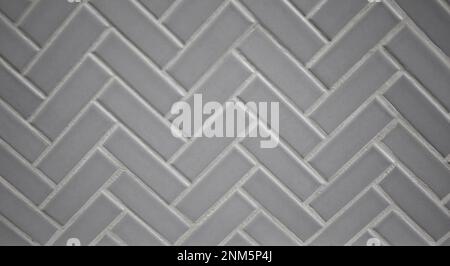 Gray Grey porcelain ceramic herringbone tile for a backsplash, kitchen, shower or bathroom Stock Photo