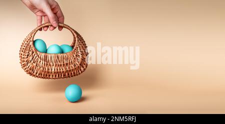 Easter eggs dyed, painted in pastel blue color in wicker basket. Ad banner, background with copy space for text. High quality photo Stock Photo