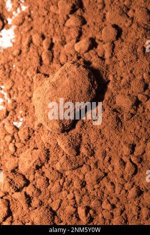 Cocoa powder, brown background, close-up. Stock Photo