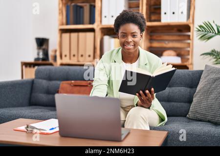African american woman psychologist working sitting on sofa at psychology center Stock Photo