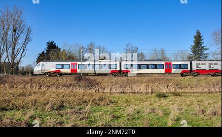 Class 755 Stadler FLIRT Bi-mode multiple unit operated by 'Greater Anglia' just north of Ely, Cambridgeshire, England Stock Photo