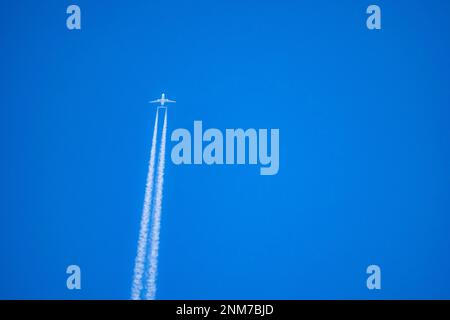 Vapor trails in thy sky from a jumbo jet at high altitude Stock Photo