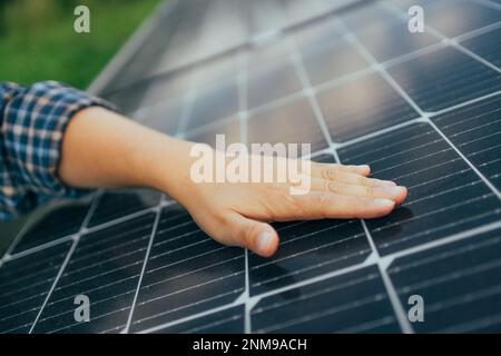 Close up of an engineer hand is checking an operation of sun and cleanliness of photovoltaic solar panels  Stock Photo