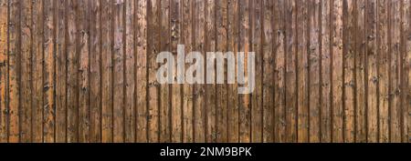 Weathered wood paneling made of vertical brown boards Stock Photo