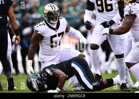 Philadelphia Eagles' Jordan Howard (24) is tackled by New Orleans Saints'  Jalyn Holmes (57) during the second half of an NFL football game, Sunday,  Nov. 21, 2021, in Philadelphia. (AP Photo/Derik Hamilton