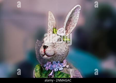 Easter rabbit figurine  head and shoulders 2 - dressed in shiny clothes - abstract blurred background and room for copy Stock Photo