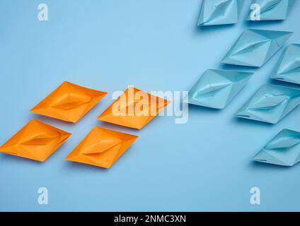 Two groups of paper boats facing each other, a concept of confrontation, top view Stock Photo