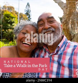 National take a walk in the park day text over happy senior african american couple in park Stock Photo