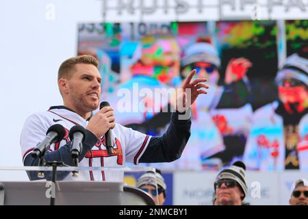 ATLANTA, GA - NOVEMBER 05: Atlanta Braves first baseman Freddie Freeman (5)  holds the World Series trophy over his head in celebration as the confetti  falls during the championship celebration for the