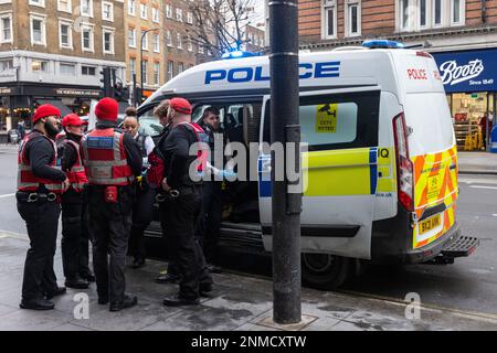 London, UK. 22nd February, 2023. Fitzrovia Partnership street wardens speak to Metropolitan Police officers in Tottenham Court Road. Fitzrovia Partnership street wardens are supplied by My Local Bobby and work closely with the police and the local authority. They have no power of arrest. Credit: Mark Kerrison/Alamy Live News Stock Photo