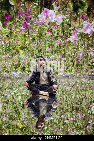 Toshiyuki Inoko poses for a photo amid an art work Floating Flower Garden:  Flowers and I are of the Same Root, the Garden and I are One, at teamLab  Planets TOKYO in