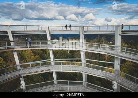 Bad Wildbad, Germany - October 13, 2020: People tourists walking on observation tower and treetop path (germ. Baumwipfelpfad) Black Forest (germ. Schw Stock Photo