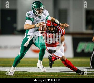 Saskatchewan Roughriders quarterback Cody Fajardo, left, is sacked by  Calgary Stampeders' Stefen Banks during first-half CFL football game action  against the Saskatchewan Roughriders in Calgary, Alberta, Saturday, Oct.  23, 2021. (Jeff McIntosh/The