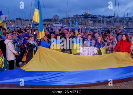 Marseille, France. 24th Feb, 2023. Protesters hold flags during the anniversary rally for peace in Ukraine. On the anniversary of the Russian attack on Ukraine, activists and the Ukrainian community living in Marseilles (France) gathered in front of the town hall of Marseilles to protest against this war and hope to see an end to it. Credit: SOPA Images Limited/Alamy Live News Stock Photo