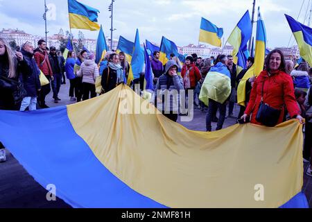 Marseille, France. 24th Feb, 2023. Protesters hold flags during the anniversary rally for peace in Ukraine. On the anniversary of the Russian attack on Ukraine, activists and the Ukrainian community living in Marseilles (France) gathered in front of the town hall of Marseilles to protest against this war and hope to see an end to it. (Photo by Denis Thaust/SOPA Images/Sipa USA) Credit: Sipa USA/Alamy Live News Stock Photo