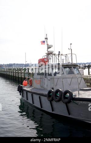 Boat with words PILOT on outside.  Docked in Newport Harbor on a cloudy, winter day in Rhode Island, USA. Stock Photo