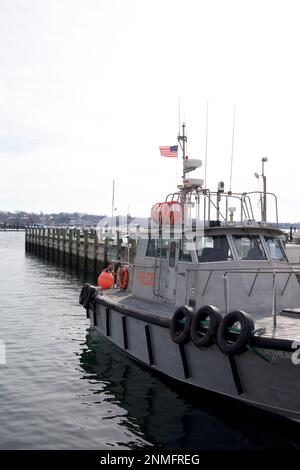 Boat with words PILOT on outside.  Docked in Newport Harbor on a cloudy, winter day in Rhode Island, USA. Stock Photo