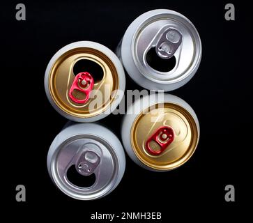 Three opened and one unopened beer cans Stock Photo