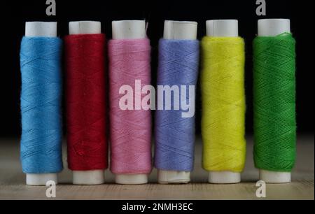 Six rolls of sewing thread in different colours Stock Photo