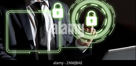 Businessman in office suit sitting at the table ant typing important message with laptop. Futuristic digital design with colored glow presenting Stock Photo