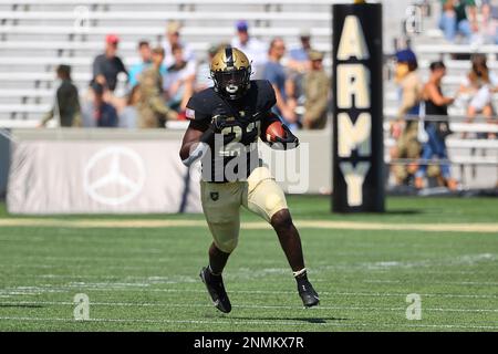 U.S. President Donald Trump is presented with a jersey and a helmet by  running back Darnell Woolfolk (R) during an event with the Army Black  Knights football team from the U.S. Military