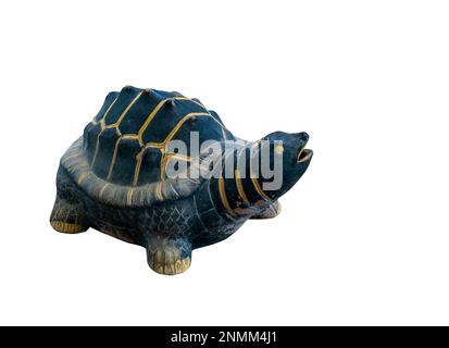 A cute turtle made of clay for garden decoration, old condition from weather, painted with dark green color and gold for the line. Isolated image on w Stock Photo