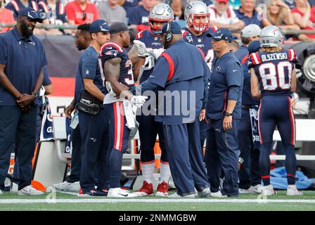 New England Patriots running backs coach Vinnie Sunseri wears an Italian  flag on his arm on the sideline during the second half of an NFL football  game against the Detroit Lions, Sunday