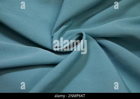 Turquoise fabric background. Turquoise cloth waves background texture. Turquoise fabric cloth textile material. Stock Photo