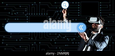 Businessman in black office suit standing wearing VR glasses and looking at technological message. Man pressing virtual buttons with his both fingers Stock Photo