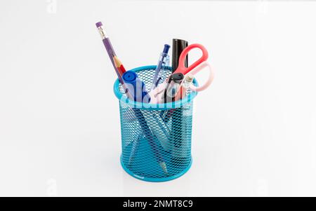 Stationery in blue mesh holder isolated on white background Stock Photo