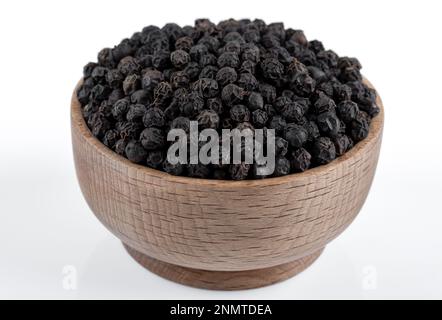 Bowl full of black pepper on a white background,closeup Stock Photo