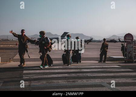 A Marine assigned to the 24th Marine Expeditionary Unit (MEU) escorts Department of State personnel to be processed for evacuation at Hamid Karzai International Airport, in Kabul, Afghanistan, Sunday, Aug. 15, 2021. (Sgt. Isaiah Campbell/U.S. Marine Corps via AP)