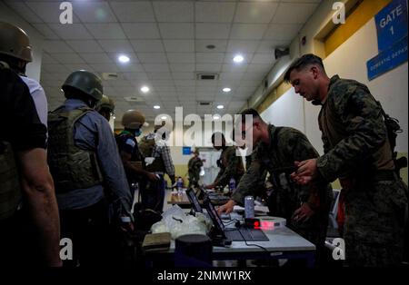 Marines of the 24th Marine Expeditionary Unit (MEU) process Department of State personnel for evacuation at Hamid Karzai International Airport, in Kabul, Afghanistan, Sunday, Aug. 15, 2021. (Sgt. Isaiah Campbell/U.S. Marine Corps via AP)