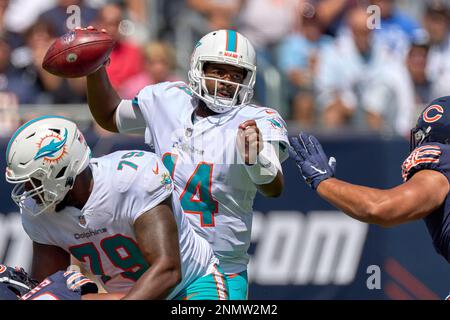 CHICAGO, IL - AUGUST 14: Miami Dolphins quarterback Tua Tagovailoa (1)  throws the football in warmups during a preseason game between the Chicago  Bears and the Miami Dolphins on August 14, 2021