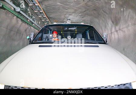 ORDOS, CHINA - FEBRUARY 24, 2023 - A new energy trackless rubber wheel vehicle equipped with a driverless system runs underground at the Shendong Coal Stock Photo